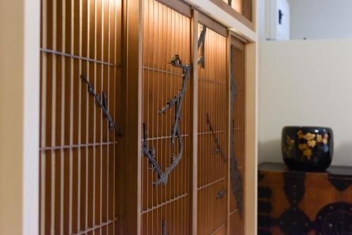 a pair of wooden doors with bows on them at Yoyogi House in Tokyo