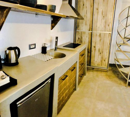 a kitchen with a sink and a counter at Aeris suites in Koufonisia