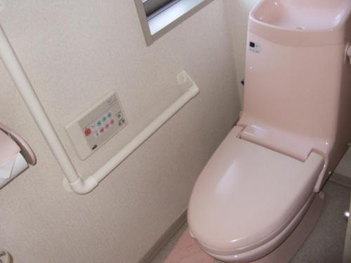 a bathroom with a white toilet with a handicap rail at tomy&tetu in Kyoto
