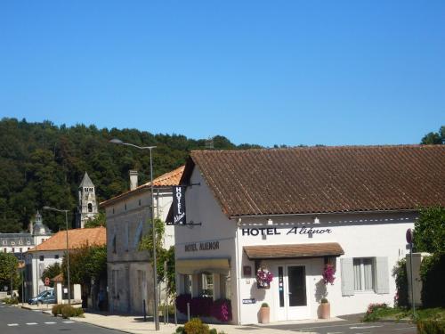 a small town with a building and a church at Hotel Alienor in Brantôme