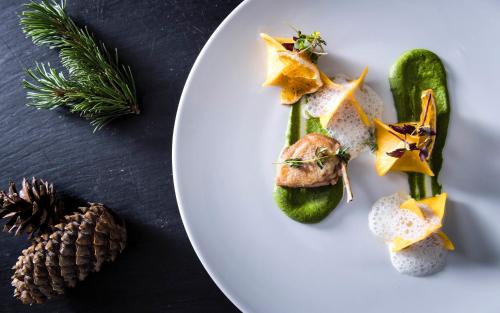 a white plate with food on a table at Apartment Lodge Gasserhof in Bressanone