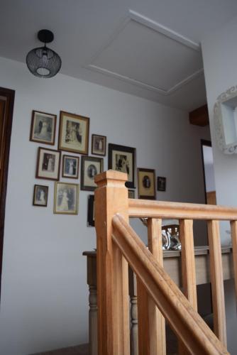 a room with pictures on the wall and a staircase at La Grange Des Biches in Benque-Dessous-et-Dessus
