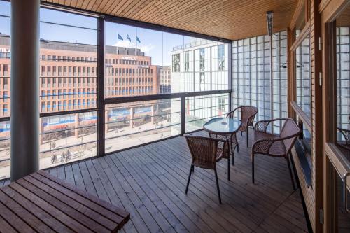 a balcony with a table and chairs and a view at Luxury City Center Apartments in Helsinki