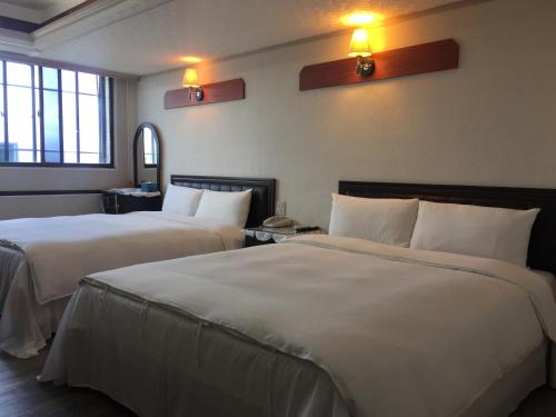 מיטה או מיטות בחדר ב-King Lo Tung Hotel