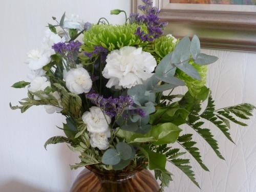 a vase filled with white and purple flowers at Burnside Guest House in Ayr