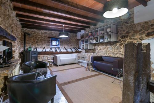 a living room with a stone wall at Hotel Turixant in Mancor del Valle