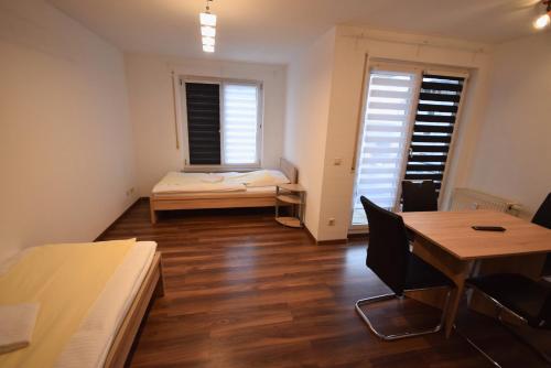 a room with a bed and a desk and a table at AB Apartment Objekt 72 in Vaihingen