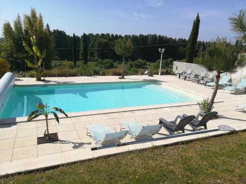 a swimming pool with lounge chairs and a swimming pool at Le Pigeonnier du Perron Hôtel in Availles en Chatellerault