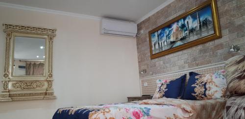 a bedroom with a bed and a mirror at Shahal Apartments in Beer Sheva