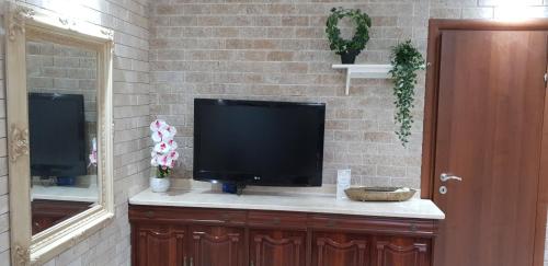 a flat screen tv sitting on top of a counter at Shahal Apartments in Beer Sheva