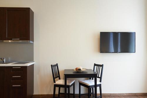 a table and chairs in a kitchen with a counter at Miramare Luxury Suites in Trieste