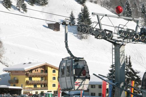 a gondola is being lifted on a ski lift at Hotel Eder Michaela in Saalbach Hinterglemm
