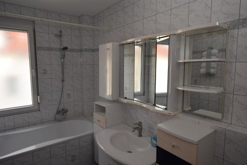 a bathroom with a sink and a toilet and a tub at Apartment Stuttgart Südheim in Stuttgart