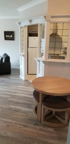 a kitchen and dining room with a wooden table at Galway City Centre Apartment, Augustine Street in Galway