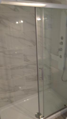 a shower with a glass door in a bathroom at Puerta del Sol in Caleta De Fuste