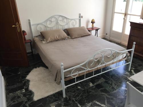 a bedroom with a bed with a metal frame at La maison du lac in Auvers-sur-Oise