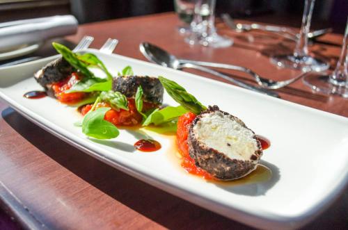 a white plate with food on a table at The Bonham in Edinburgh