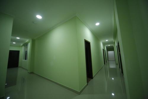 a hallway with white walls and a hallway with a door at Hotel Comfort in Kutaisi