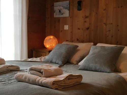 a bed with towels and pillows on top of it at Chalet Odette in Morzine