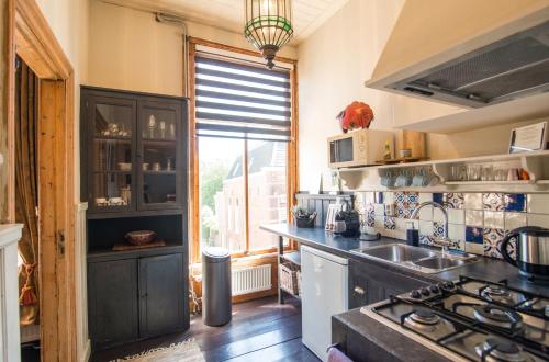a kitchen with a sink and a stove top oven at City Apartments Gorinchem in Gorinchem