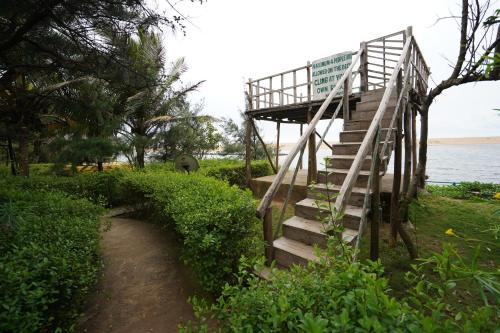 a staircase leading up to a building near the water at Lotus an Eco Resort Konark in Konārka
