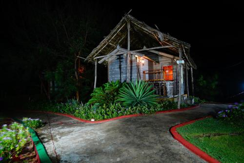a small wooden house with a red light on it at Lotus an Eco Resort Konark in Konārka