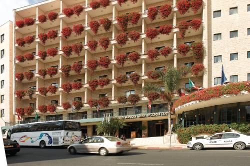 a large building with cars parked in front of it at Prima Kings Hotel in Jerusalem