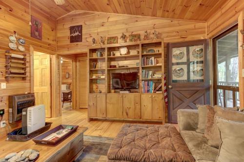 a living room with a couch and a wooden wall at River Ranch in Ellijay
