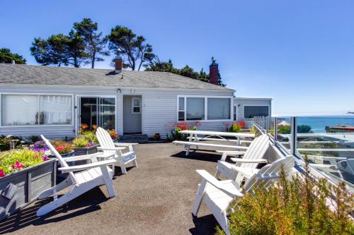 a group of white chairs sitting in front of a house at Wycliff Beach Condo in Lincoln City