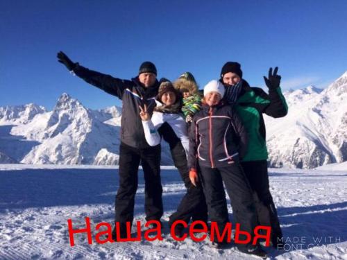 a group of people posing for a picture in the snow at U Palycha Guest House in Sukhum