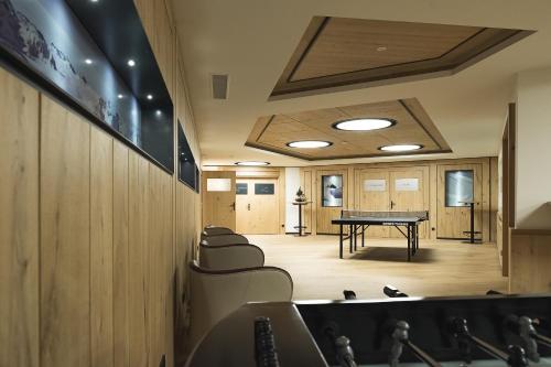 a conference room with a ping pong table in it at Hotel Zürserhof in Zürs am Arlberg