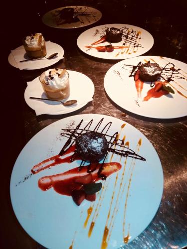 a table with several plates of desserts on them at Hotel Federico II Central Palace in Palermo