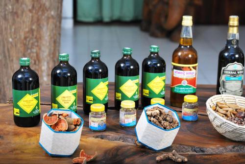 a group of bottles of wine and nuts on a table at Green Ayurvedic Beach Resort in Negombo
