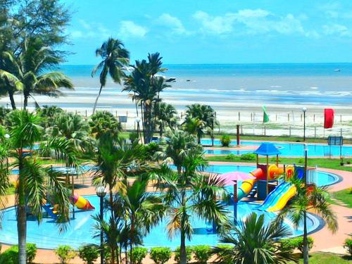 a resort with a water park with slides and a beach at De Rhu Beach Resort in Kuantan