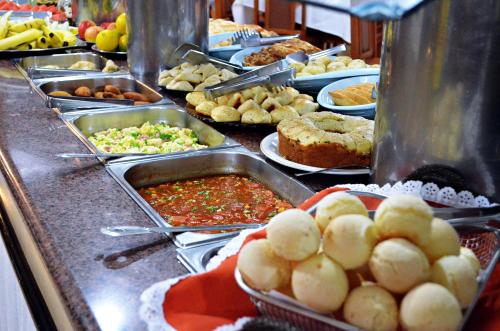 a buffet line with many different types of food at Praia Sol Hotel in Santa Terezinha de Itaipu