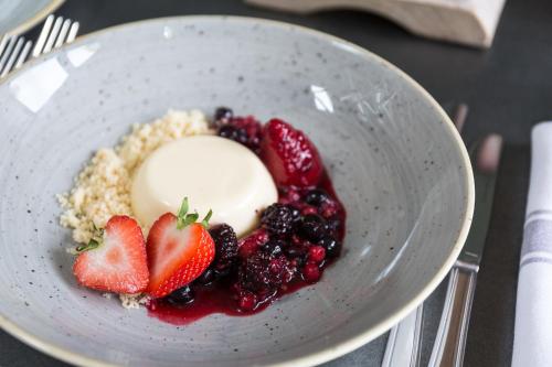 a bowl of food with berries and ice cream and strawberries at The Dundas Arms in Kintbury