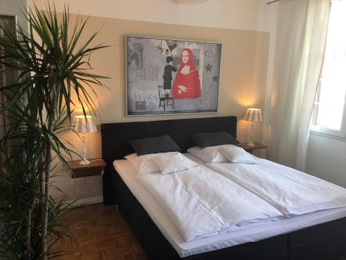 a bed in a bedroom with a picture on the wall at Hotel SchlossStuben in Nordkirchen