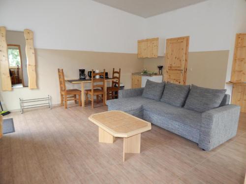 a living room with a couch and a table at Pension Bomätscher in Königstein an der Elbe