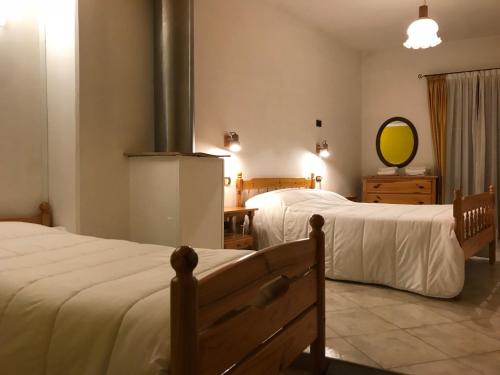 a room with two beds and a mirror on the wall at Hotel Panoramico in Corfino