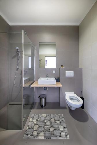a bathroom with a sink and a toilet at Hotel & Hostel Letov in Prague