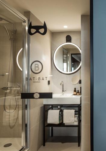 a bathroom with a sink and a mirror at Mercure Paris 17 Batignolles in Paris