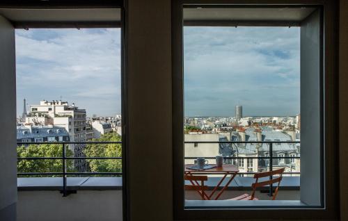 a view from a window of a table and chairs at Mercure Paris 17 Batignolles in Paris