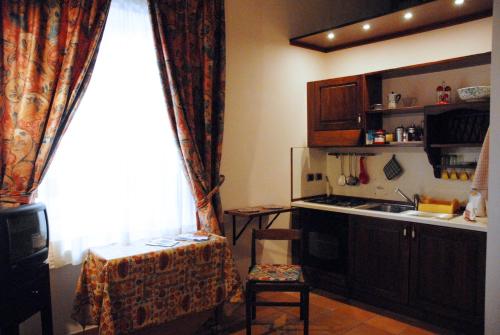 a kitchen with a table and a chair in front of a window at Dorsoduro - Corte della Comare in Venice