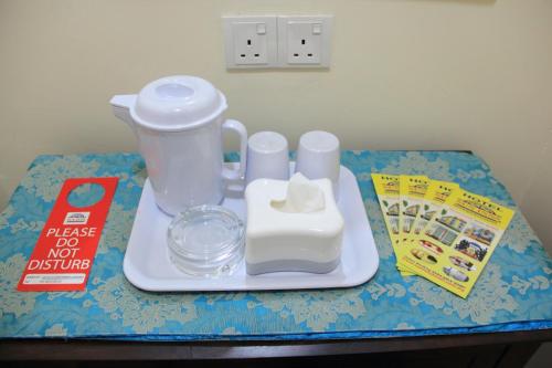a table with a toy blender and a book at Sun Inns Hotel Equine, Seri Kembangan in Seri Kembangan