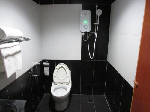 a bathroom with a toilet and a shower at Safari Hotel in Kuala Lumpur