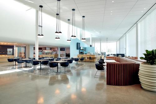 a lobby with chairs and tables in a building at Universal's Aventura Hotel in Orlando