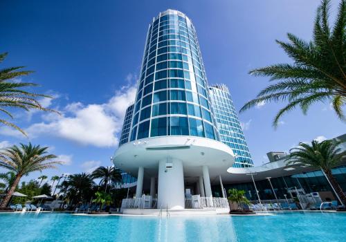 a tall building with a pool in front of it at Universal's Aventura Hotel in Orlando