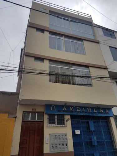 a building with a sign in front of it at Nino´s Residence Departamentos VIP Amoblados in Tacna