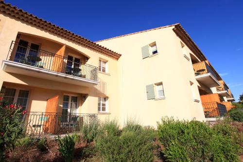 a large white building with a balcony on it at Le Domaine de Saint Endreol Golf & Spa Resort in La Motte
