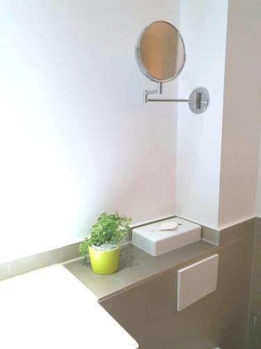 a bathroom with a sink and a mirror at SleepySleepy Hotel Dillingen in Dillingen an der Donau